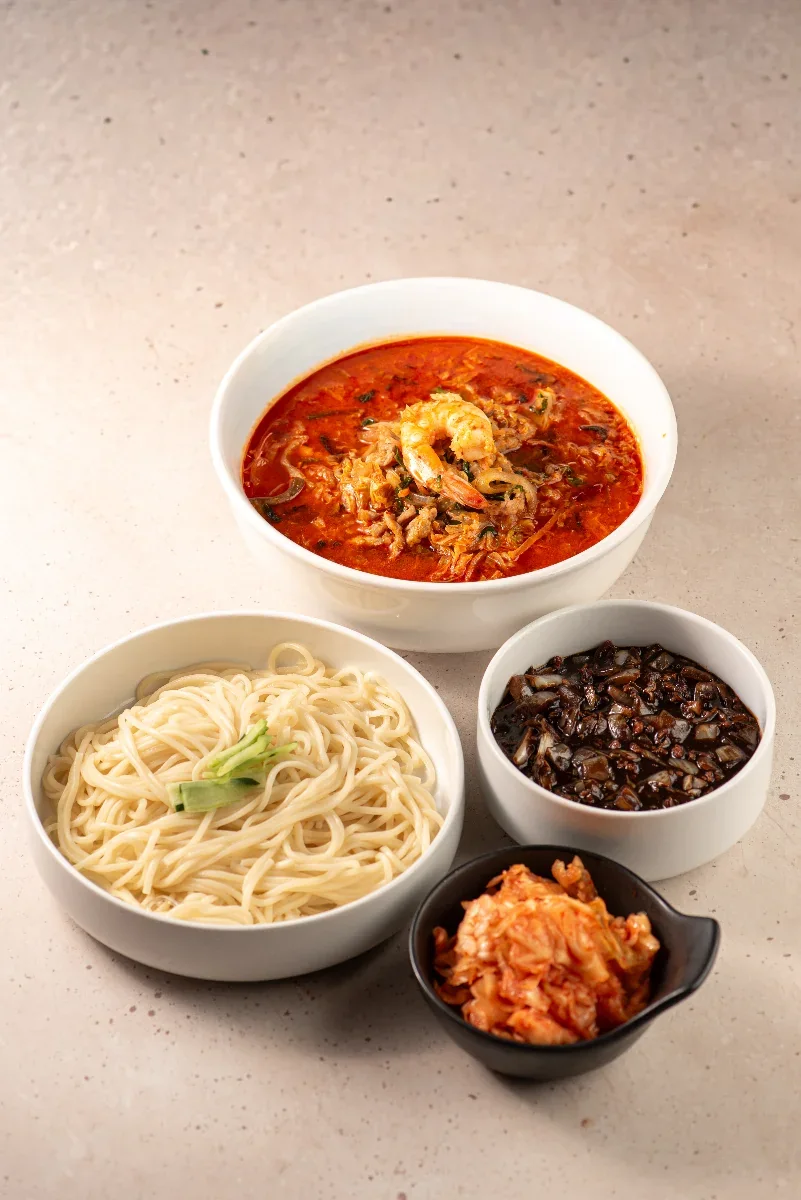 Jajangmyeon, jjamppong and Korean-Chinese dishes on the table at North China Restaurant, Houston